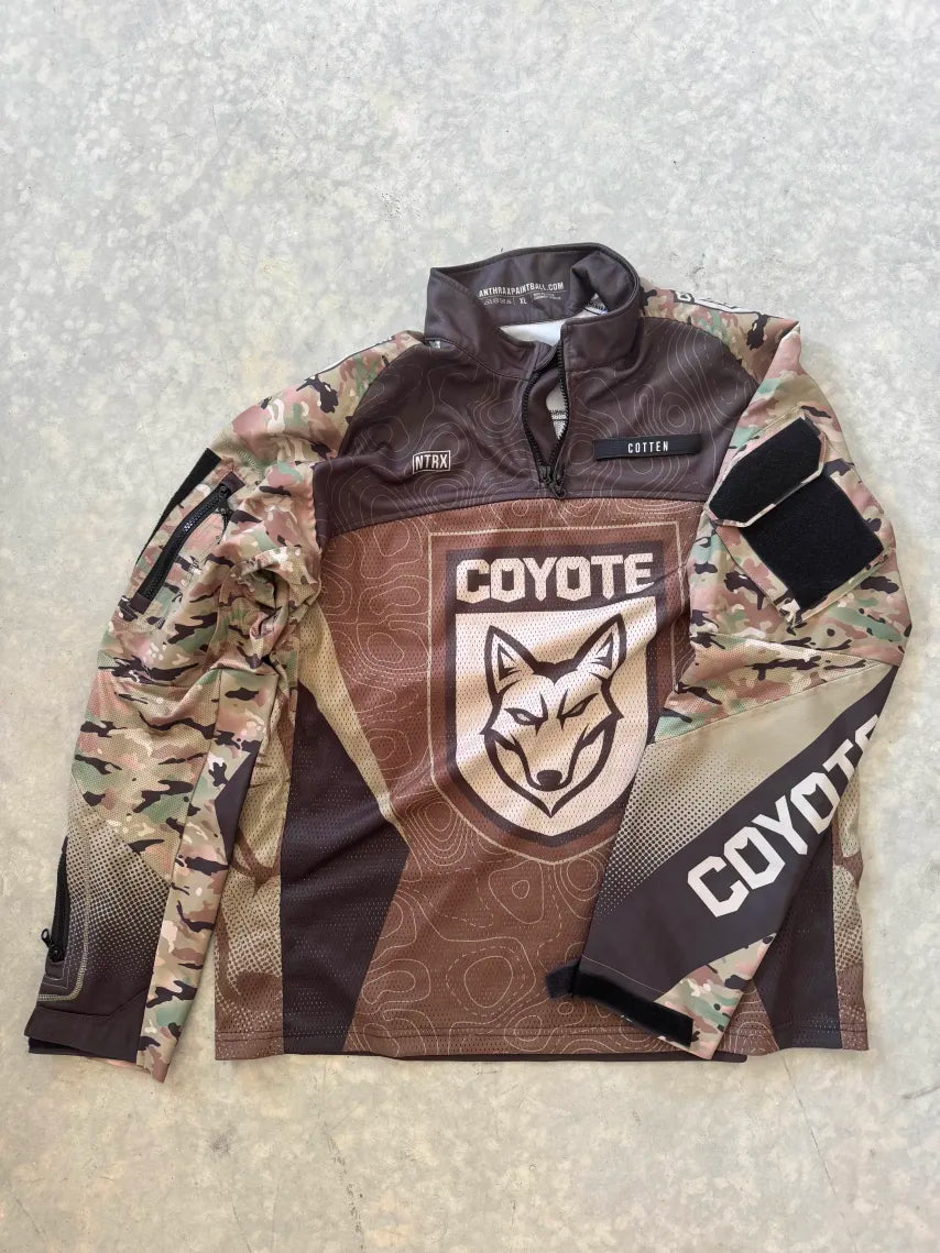 Camouflage jersey with Coyote branding on a textured surface