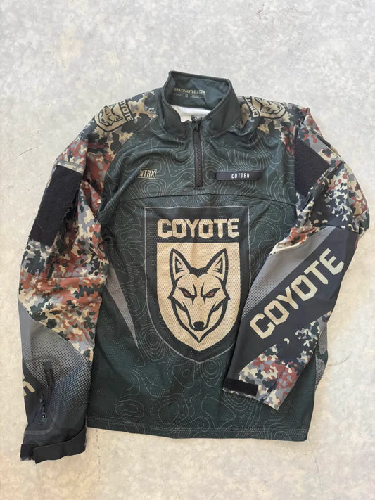 Camouflage jersey with 'Coyote' branding on a textured surface